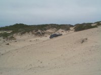 Gadget piloting his Nissan up a steep sand dune